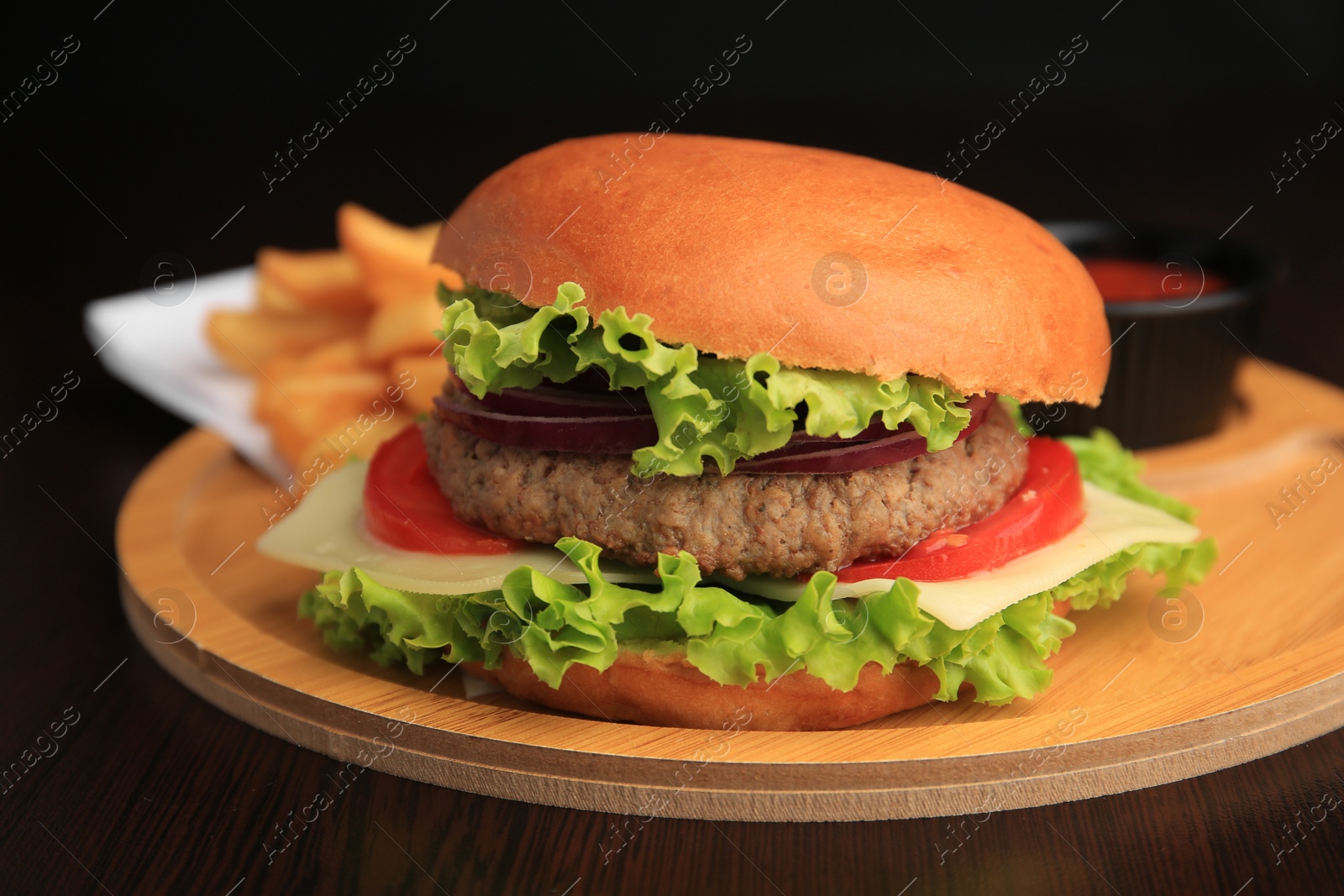 Photo of Tasty burger with vegetables, patty and cheese on wooden table, closeup