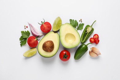 Fresh ingredients for guacamole on white background, flat lay