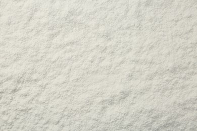 Pile of organic flour as background, top view