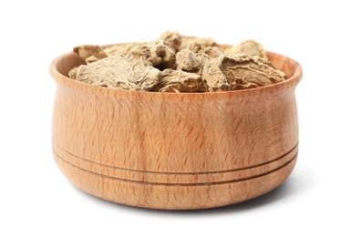 Photo of Wooden bowl with dried ginger on white background. Different spices