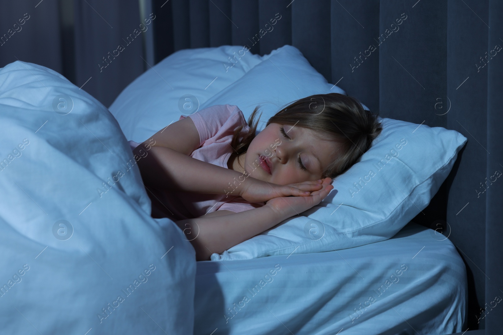 Photo of Little girl snoring while sleeping in bed at home