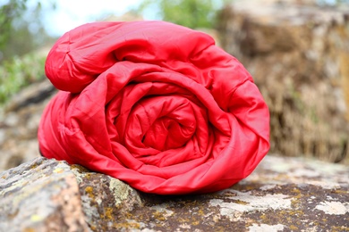 Photo of Rolled sleeping bag outdoors on sunny day, closeup