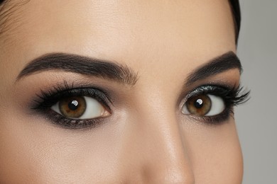 Photo of Young woman with evening makeup, closeup. Eye shadow product