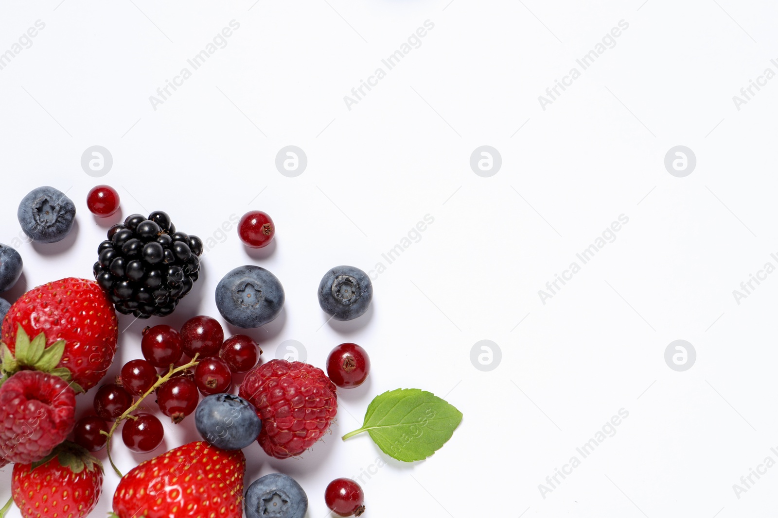 Photo of Many different fresh berries on white background, flat lay. Space for text