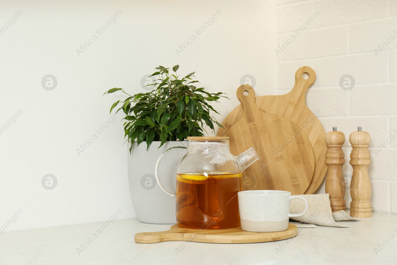 Photo of Different kitchen items and houseplant on countertop indoors