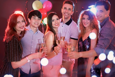 Photo of Young people celebrating birthday in nightclub