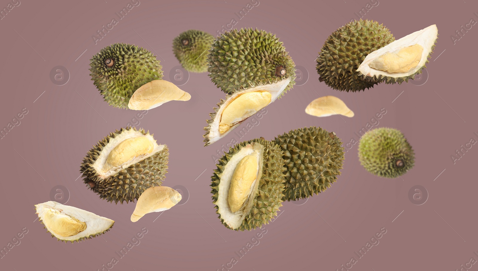 Image of Fresh ripe durians falling on color background