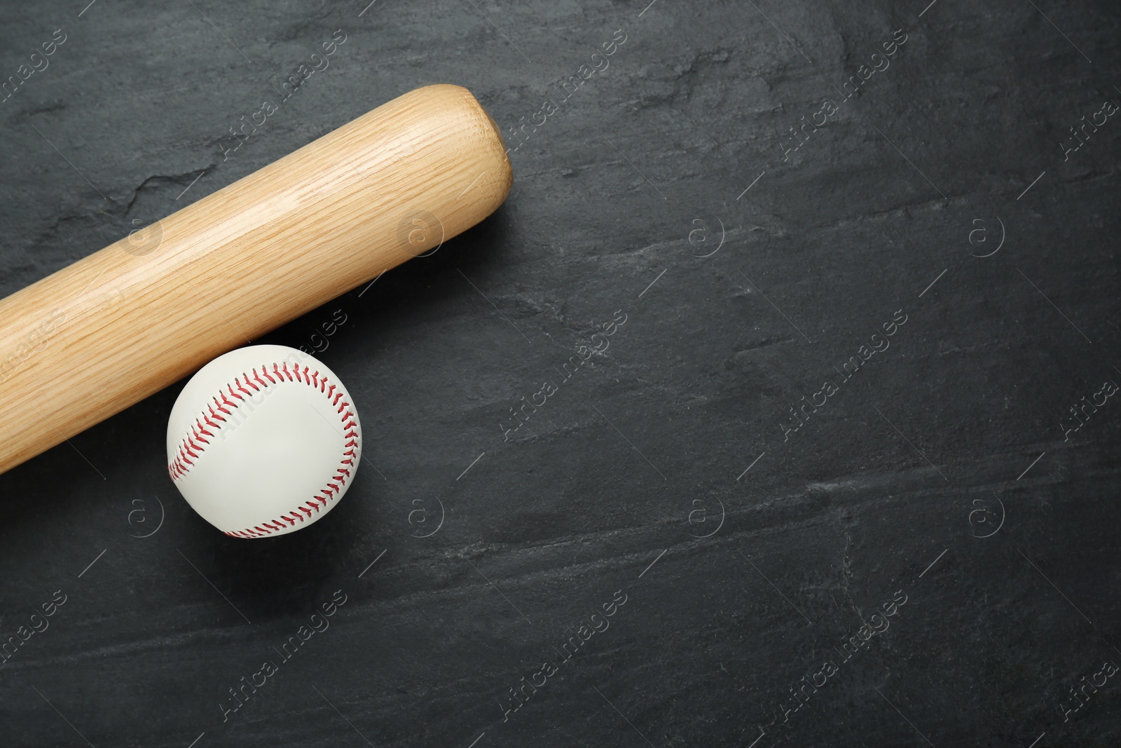 Photo of Baseball bat and ball on black background, top view with space for text. Sports equipment