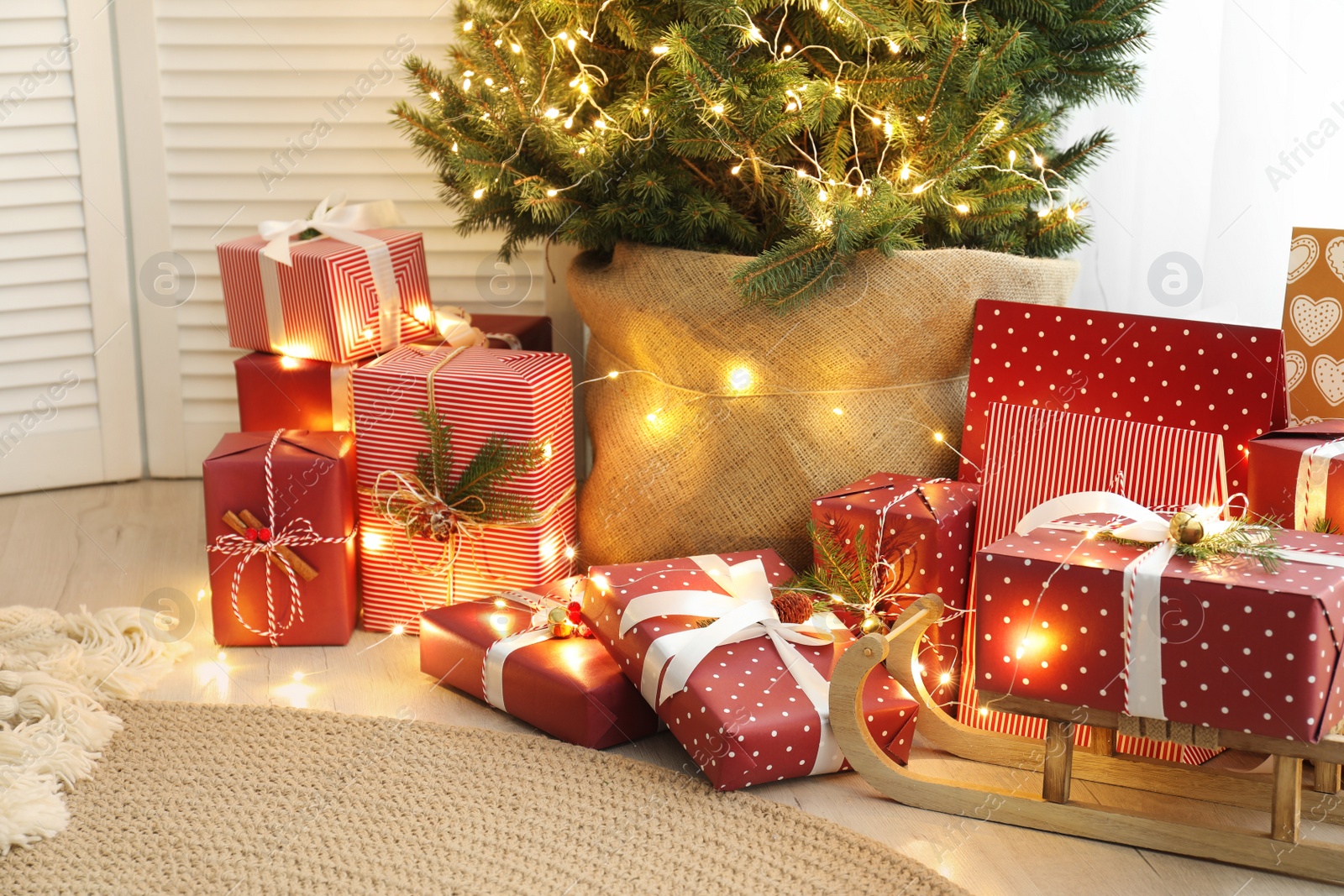 Photo of Many different gifts under Christmas tree indoors