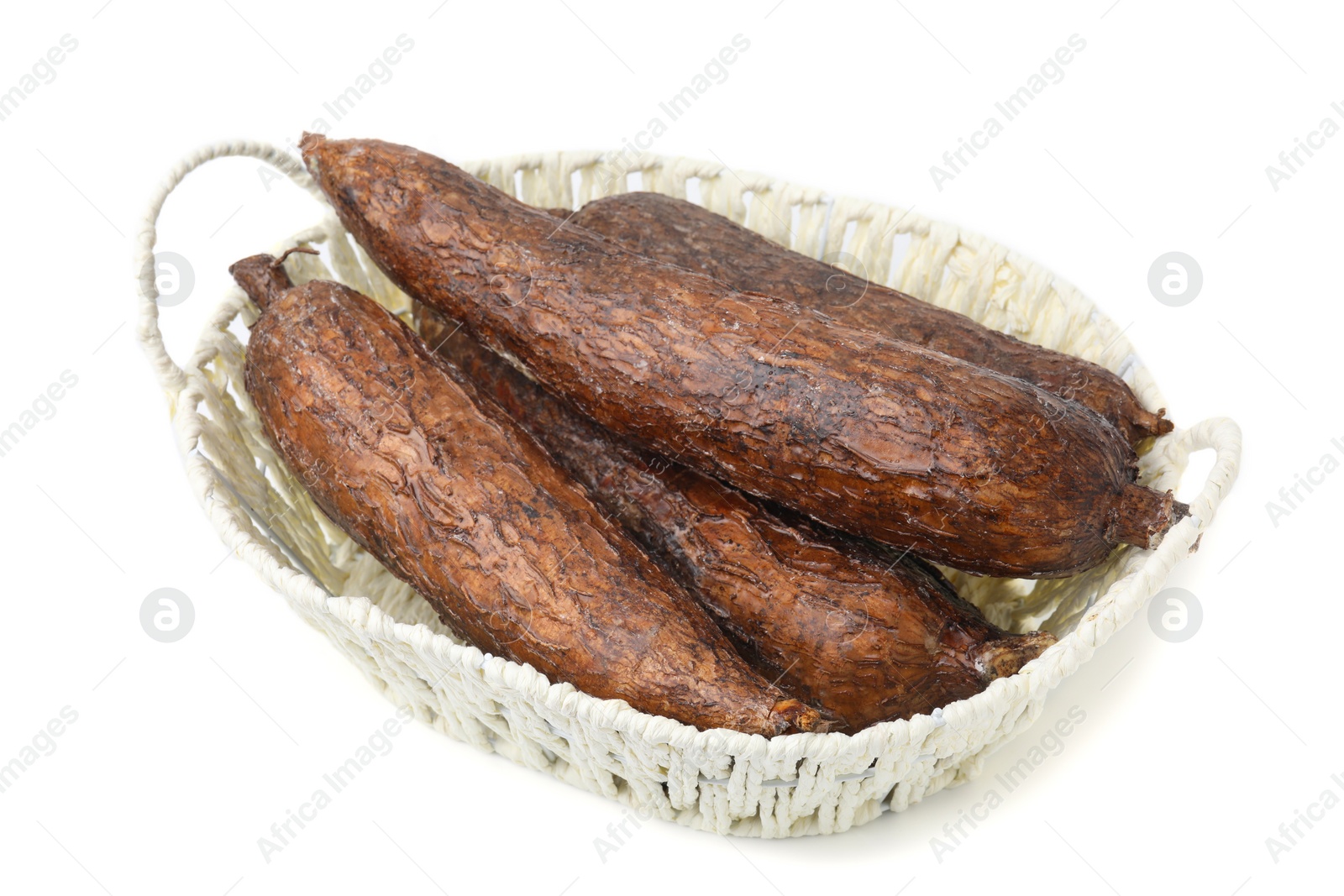 Photo of Whole cassava roots in basket isolated on white