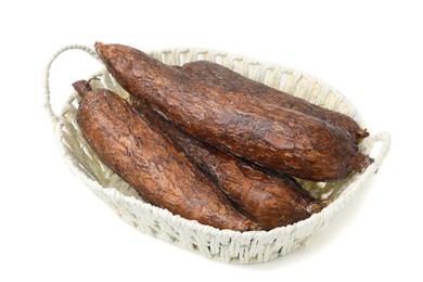 Whole cassava roots in basket isolated on white