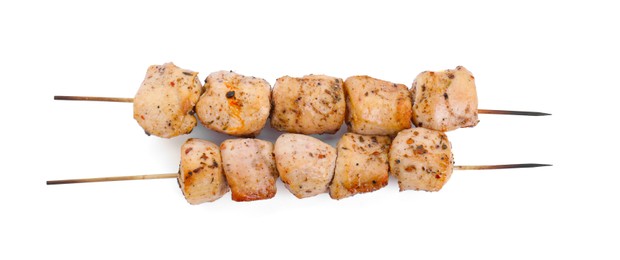 Photo of Skewers with delicious fresh shish kebabs isolated on white, top view