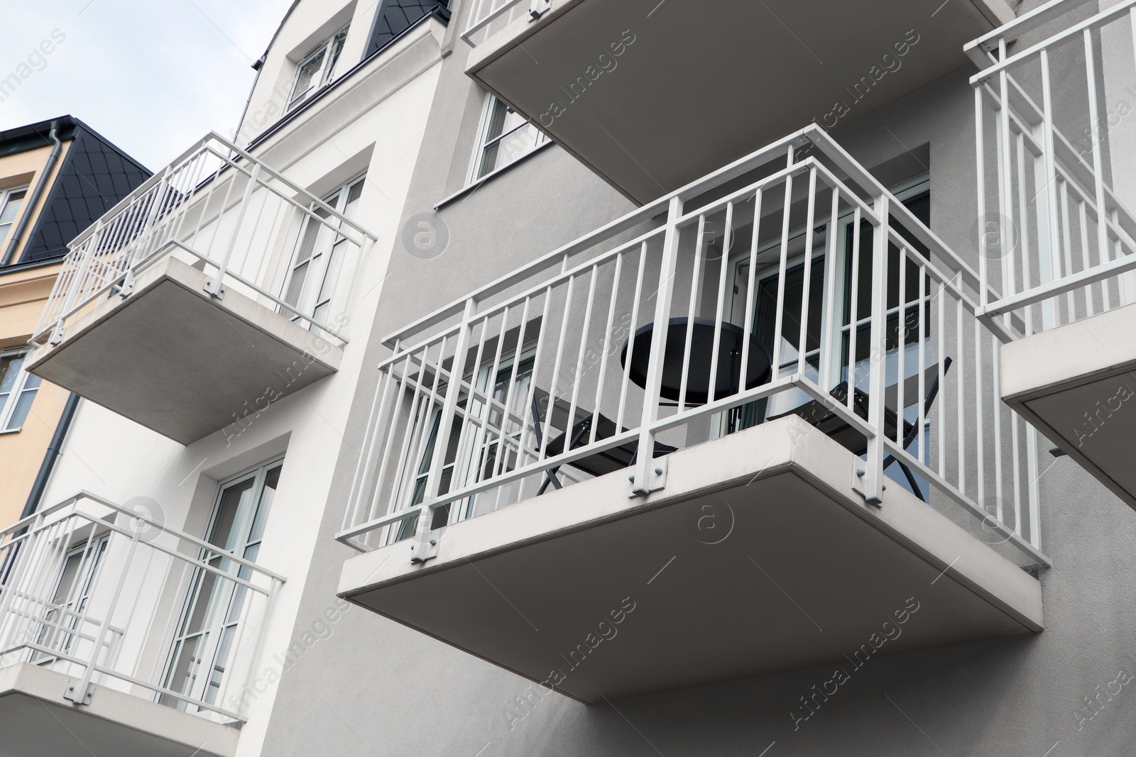 Photo of Exterior of beautiful building with balconies, low angle view