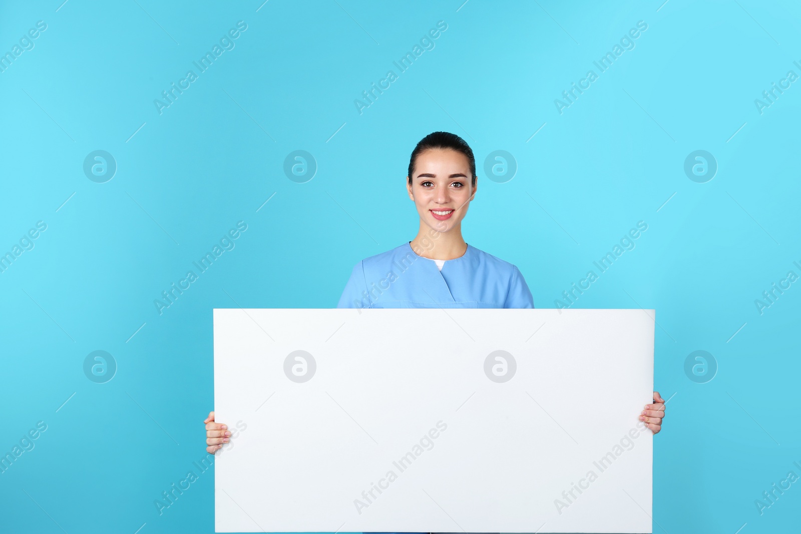 Photo of Medical student with blank poster on color background. Space for text