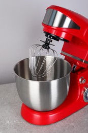 Modern red stand mixer on light gray table