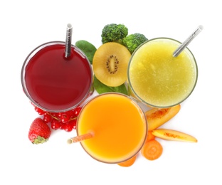 Photo of Delicious colorful juices in glasses and fresh ingredients isolated on white, top view