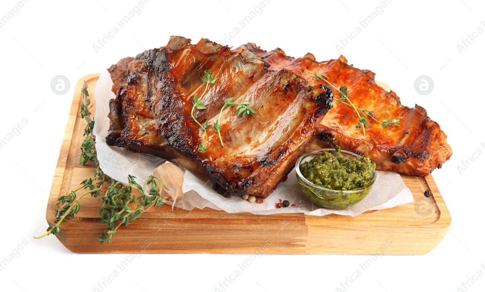 Photo of Tasty grilled ribs with sauce isolated on white