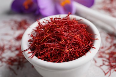 Dried saffron and crocus flowers on table, closeup