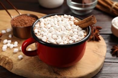 Photo of Tasty hot chocolate with marshmallows on wooden table, closeup