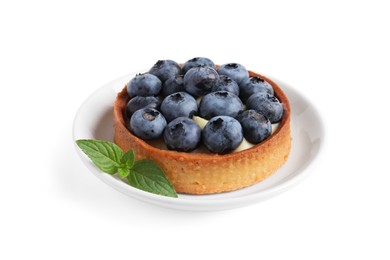 Tartlet with fresh blueberries and mint isolated on white. Delicious dessert