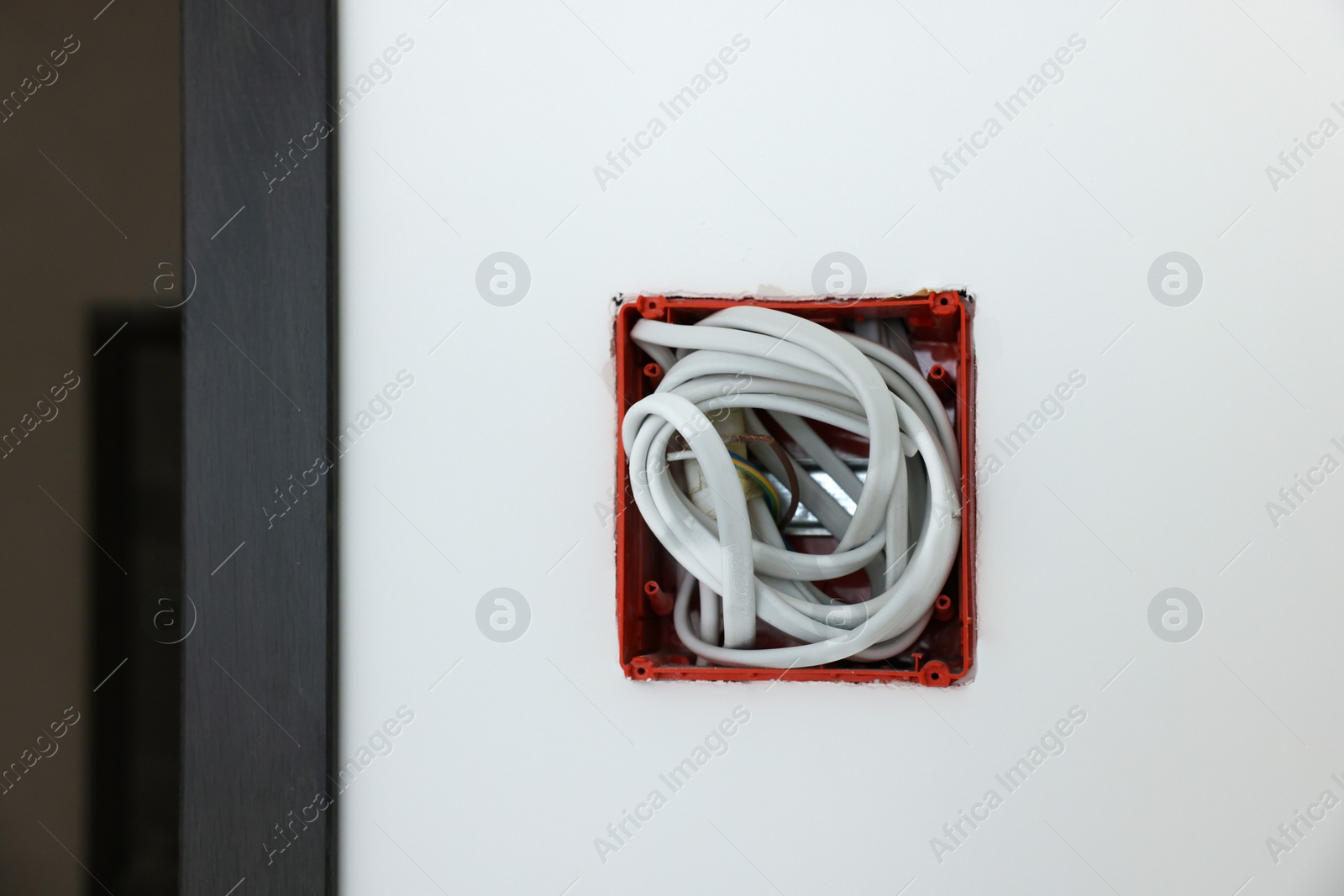 Photo of Mounting box with wires on wall, closeup