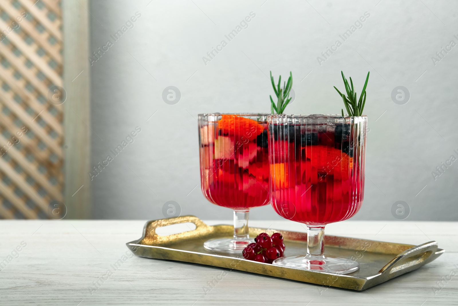 Photo of Glasses of Red Sangria on white wooden table