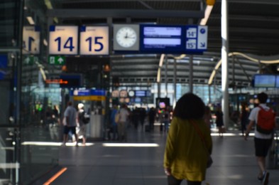 Blurred view of train station with hurrying people