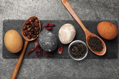 Naturally painted Easter eggs on grey table, top view. Hibiscus, tea and coffee beans used for coloring