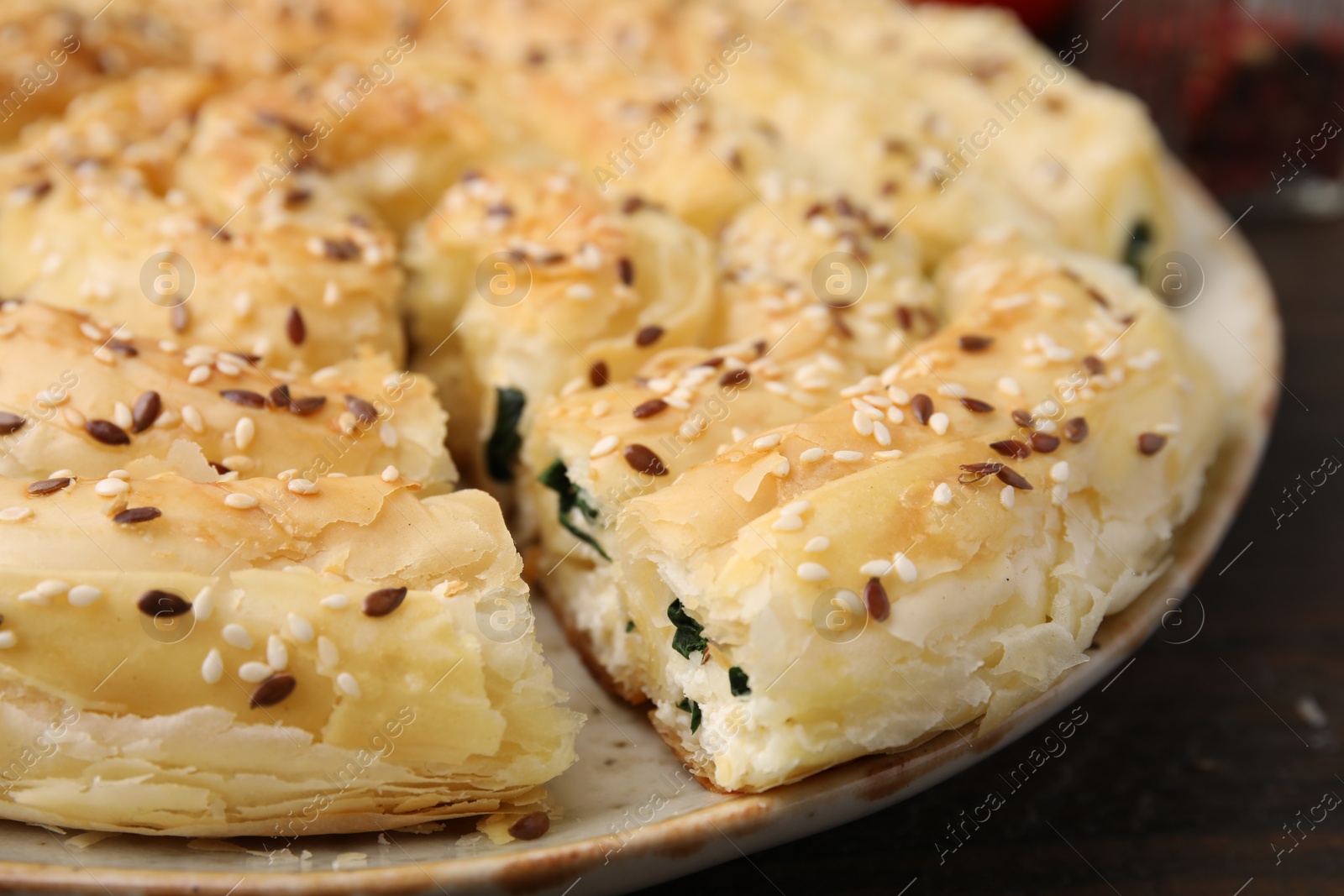 Photo of Delicious puff pastry with spinach on table, closeup