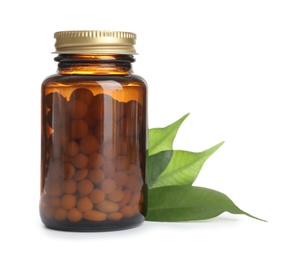 Photo of Bottle with vitamin pills and green leaves on white background