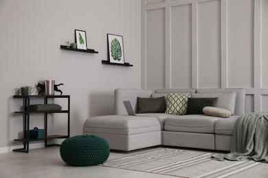 Photo of Living room with comfortable grey sofa and stylish interior elements