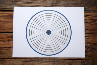 Photo of Shooting target on wooden table, top view