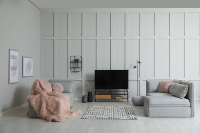 Modern TV set and modular sofa in living room. Interior design
