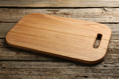 Photo of One new cutting board on old wooden table