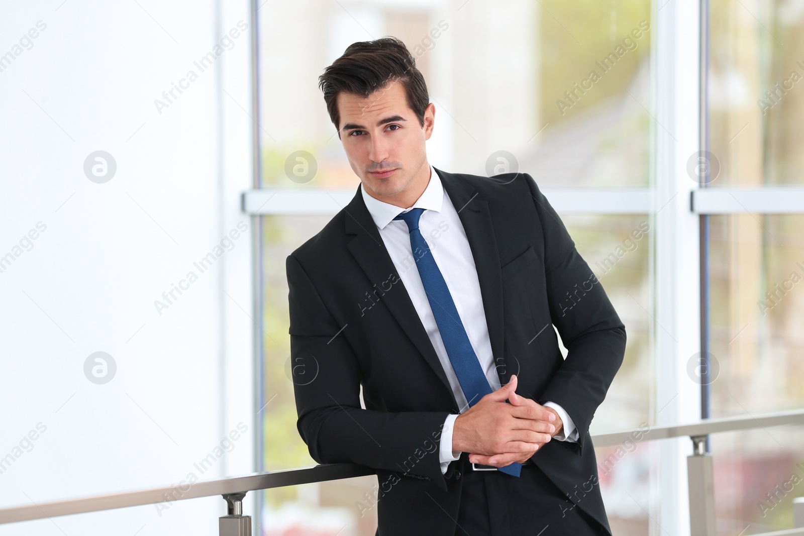 Photo of Handsome young man in stylish suit indoors
