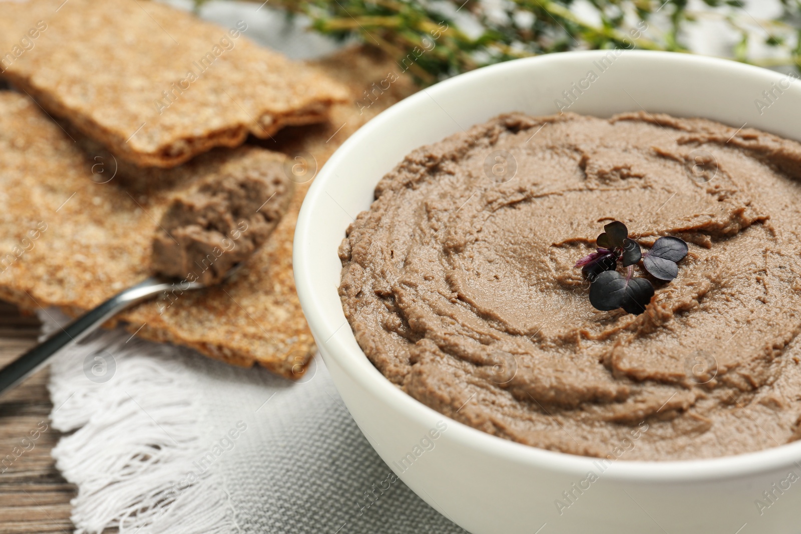 Photo of Tasty liver pate with herb on table, closeup