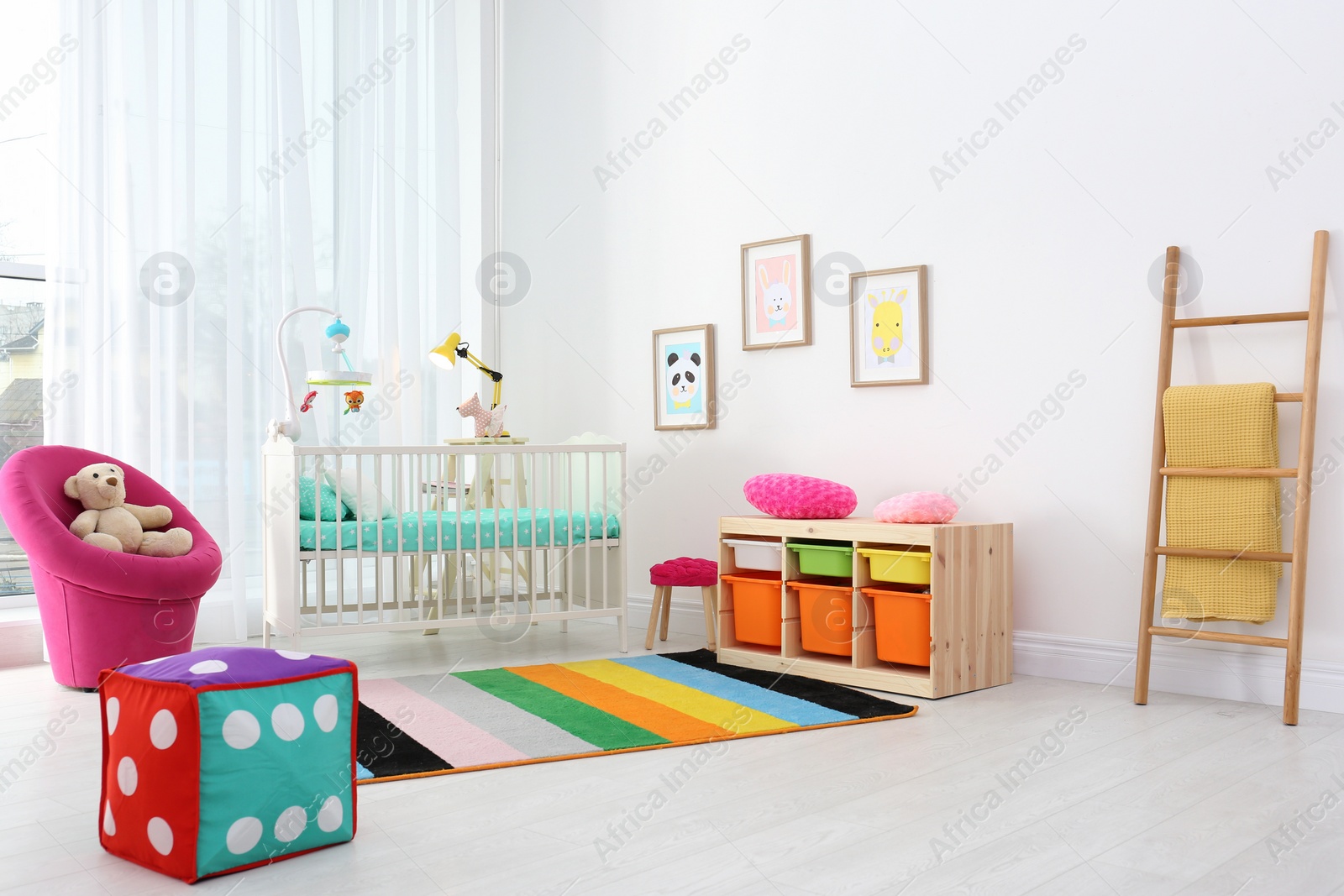 Photo of Colorful baby room interior with comfortable crib