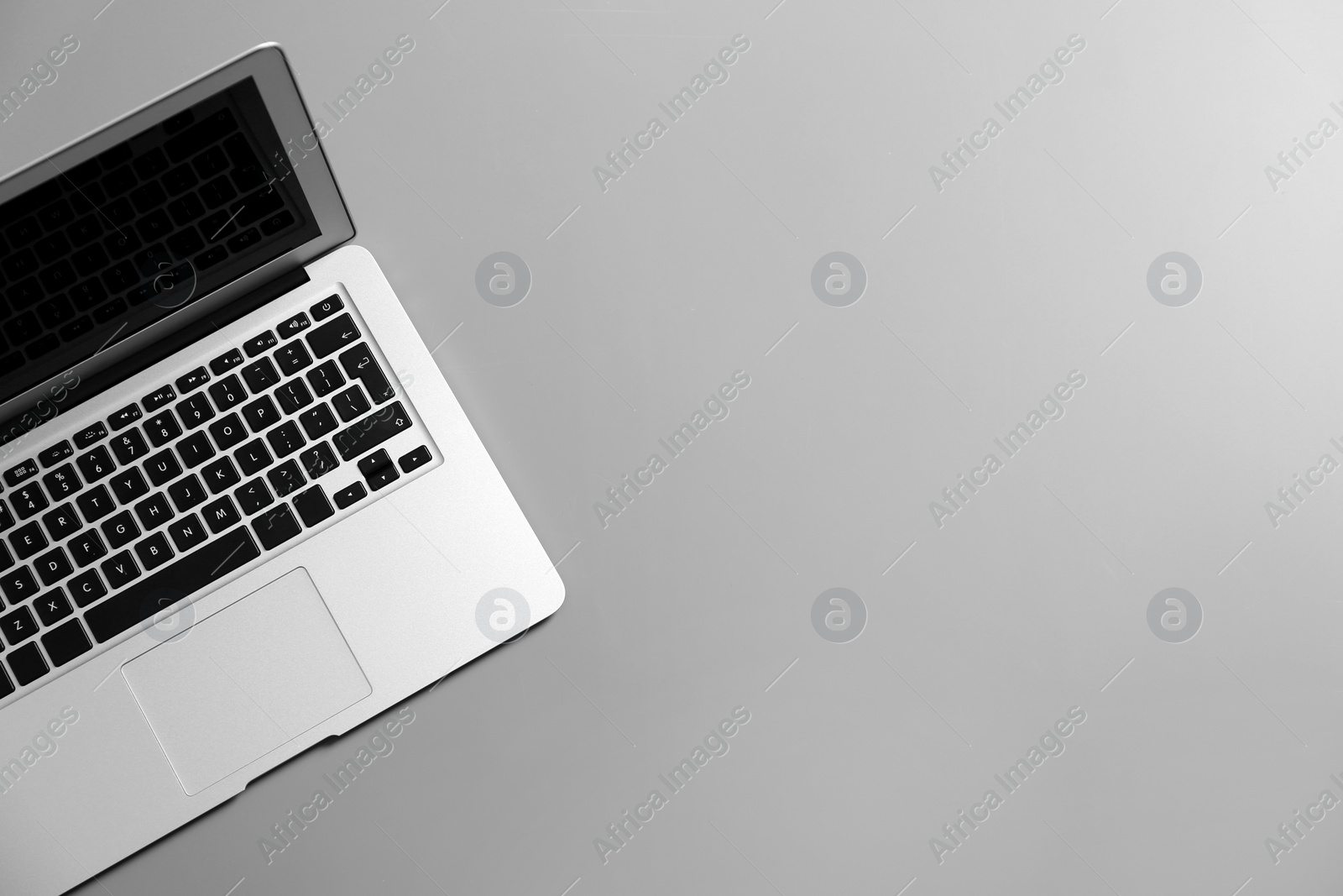 Photo of Modern laptop on gray background, top view