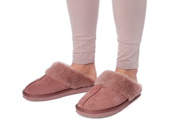 Photo of Woman in pink soft slippers on white background, closeup