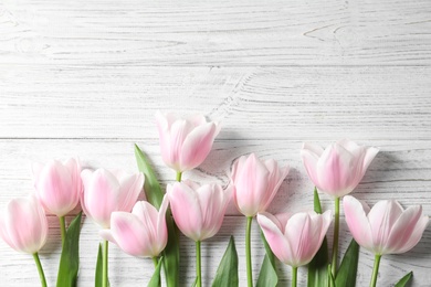 Photo of Beautiful composition with tulips for Mother's Day on wooden background