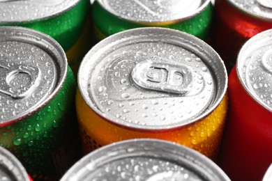 Photo of Energy drinks in wet cans, closeup. Functional beverage