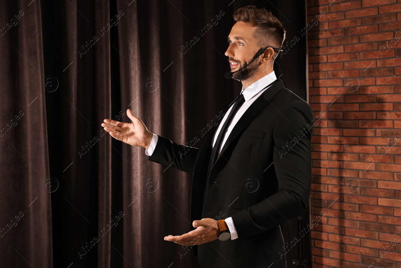 Photo of Motivational speaker with headset performing on stage