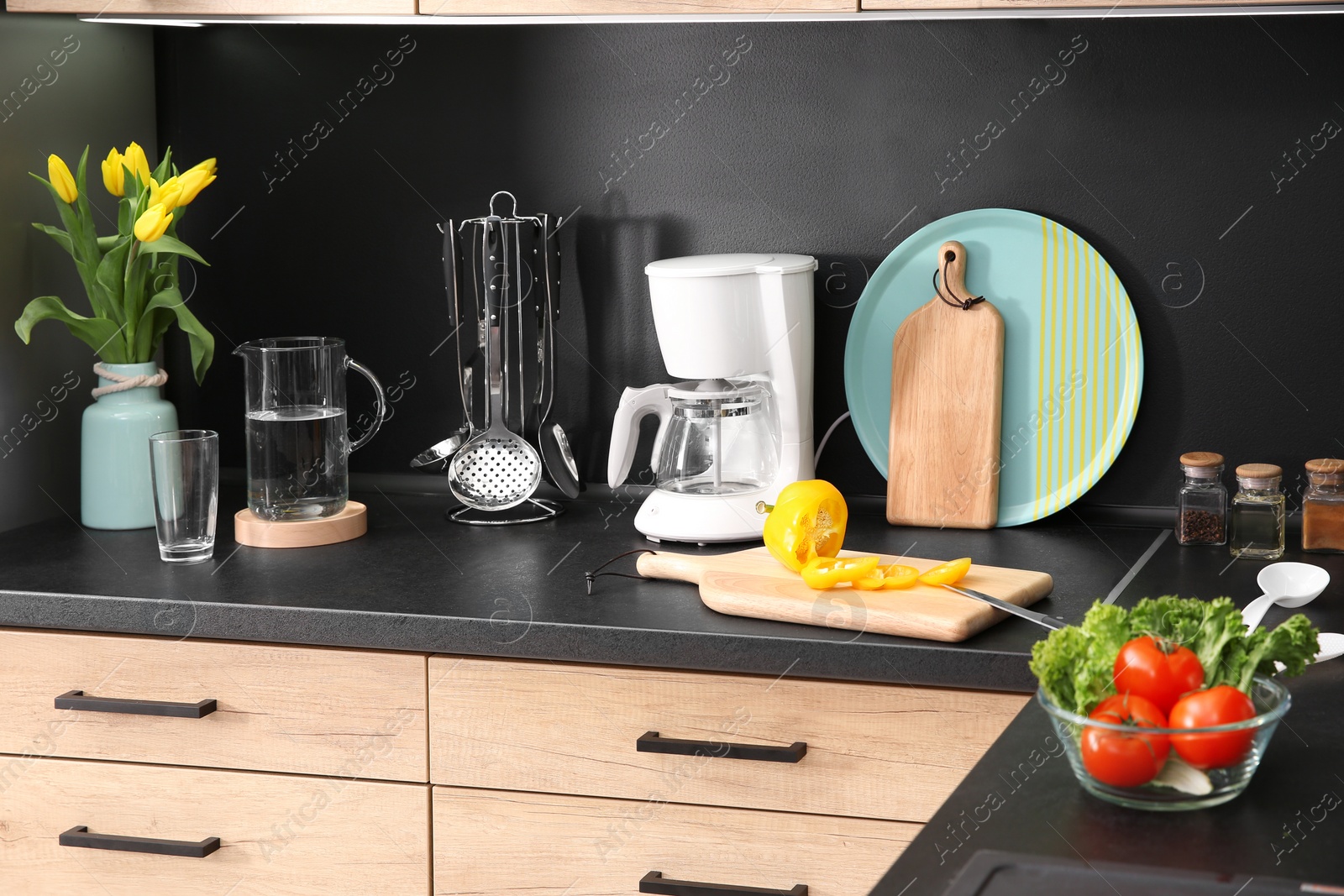 Photo of Stylish kitchen counter with houseware and products