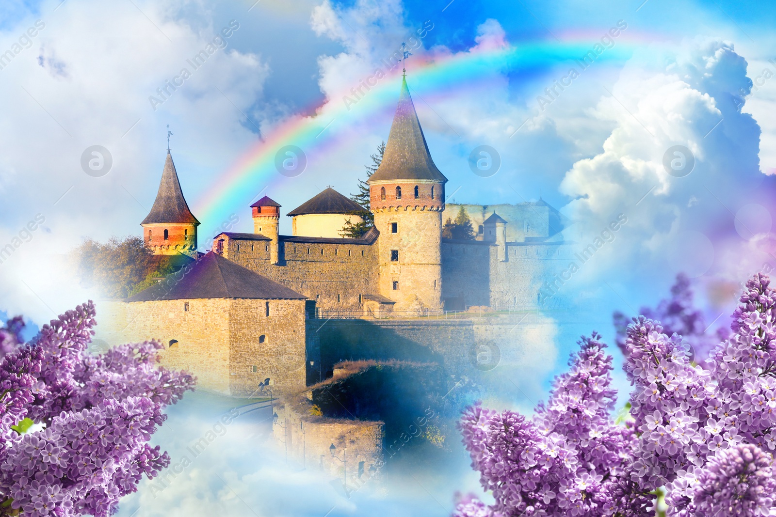 Image of Fantasy world. Beautiful rainbow in sky with fluffy clouds over enchanted castle