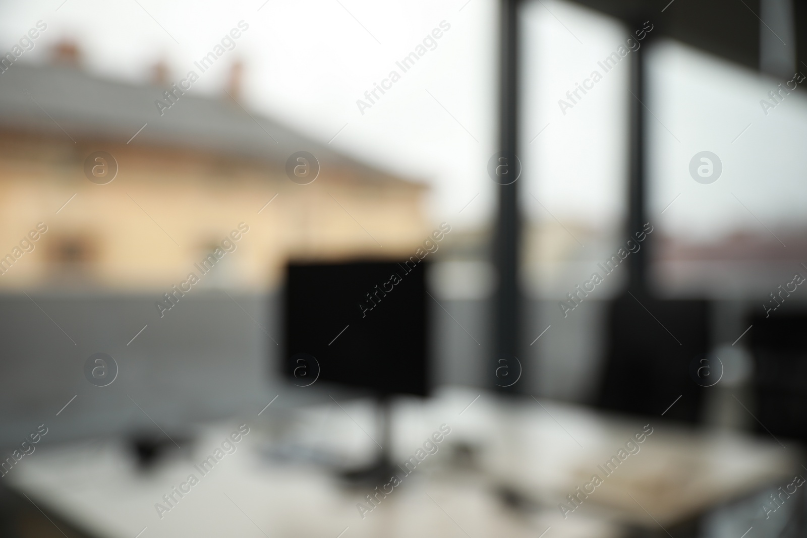 Photo of Blurred view of cozy workspaces with tables and chairs in office