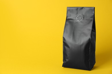 Photo of One blank foil package on yellow background. Space for text