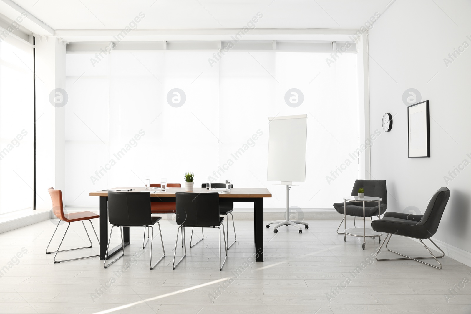 Photo of Simple office interior with large table and chairs