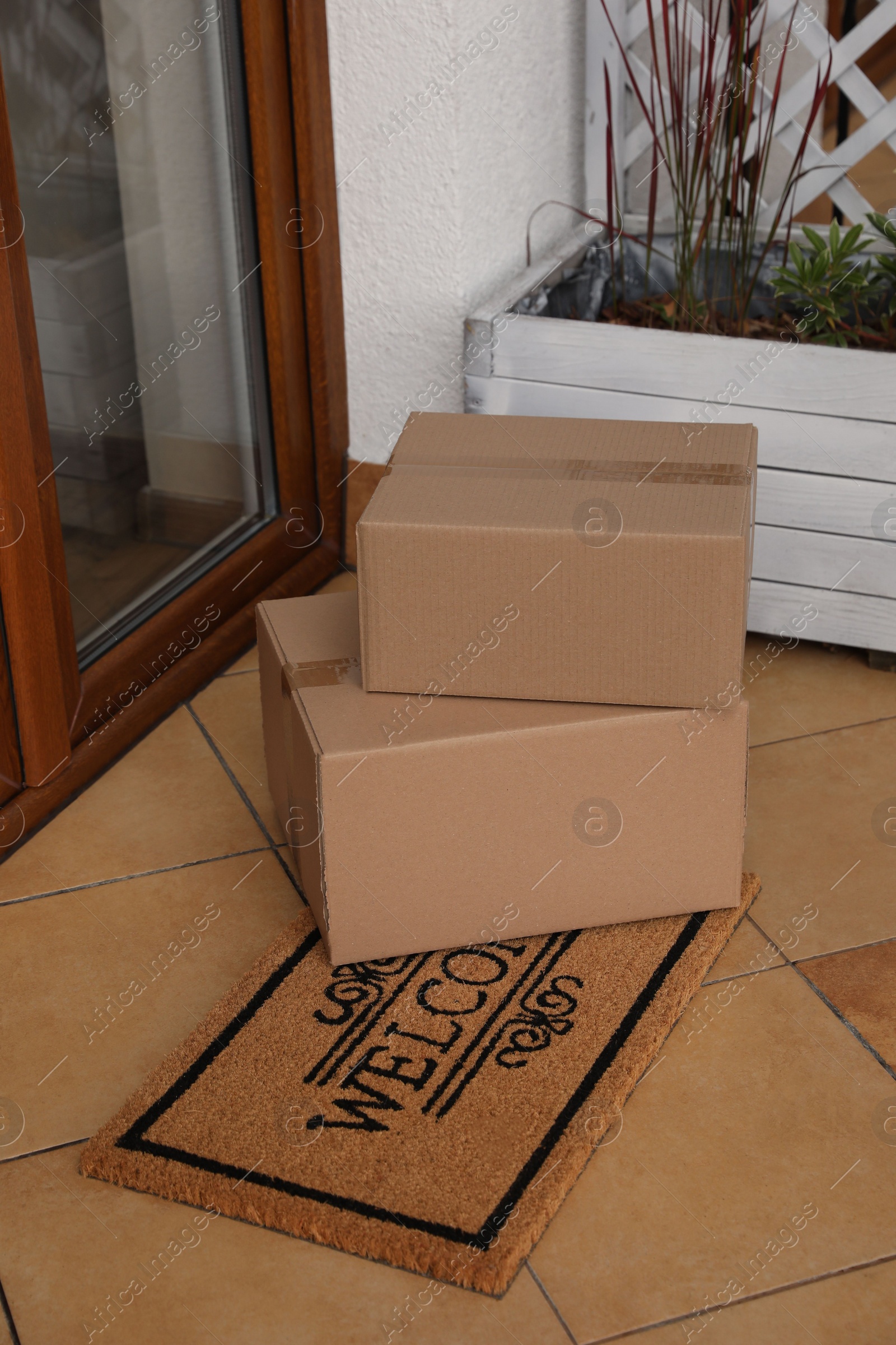 Photo of Parcels delivered on mat near front door