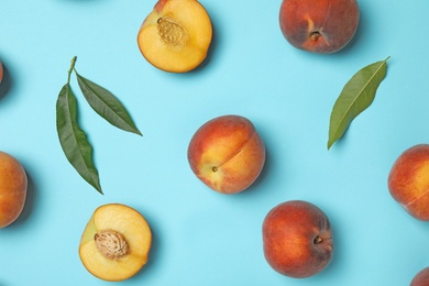 Photo of Flat lay composition with sweet juicy peaches on light blue background