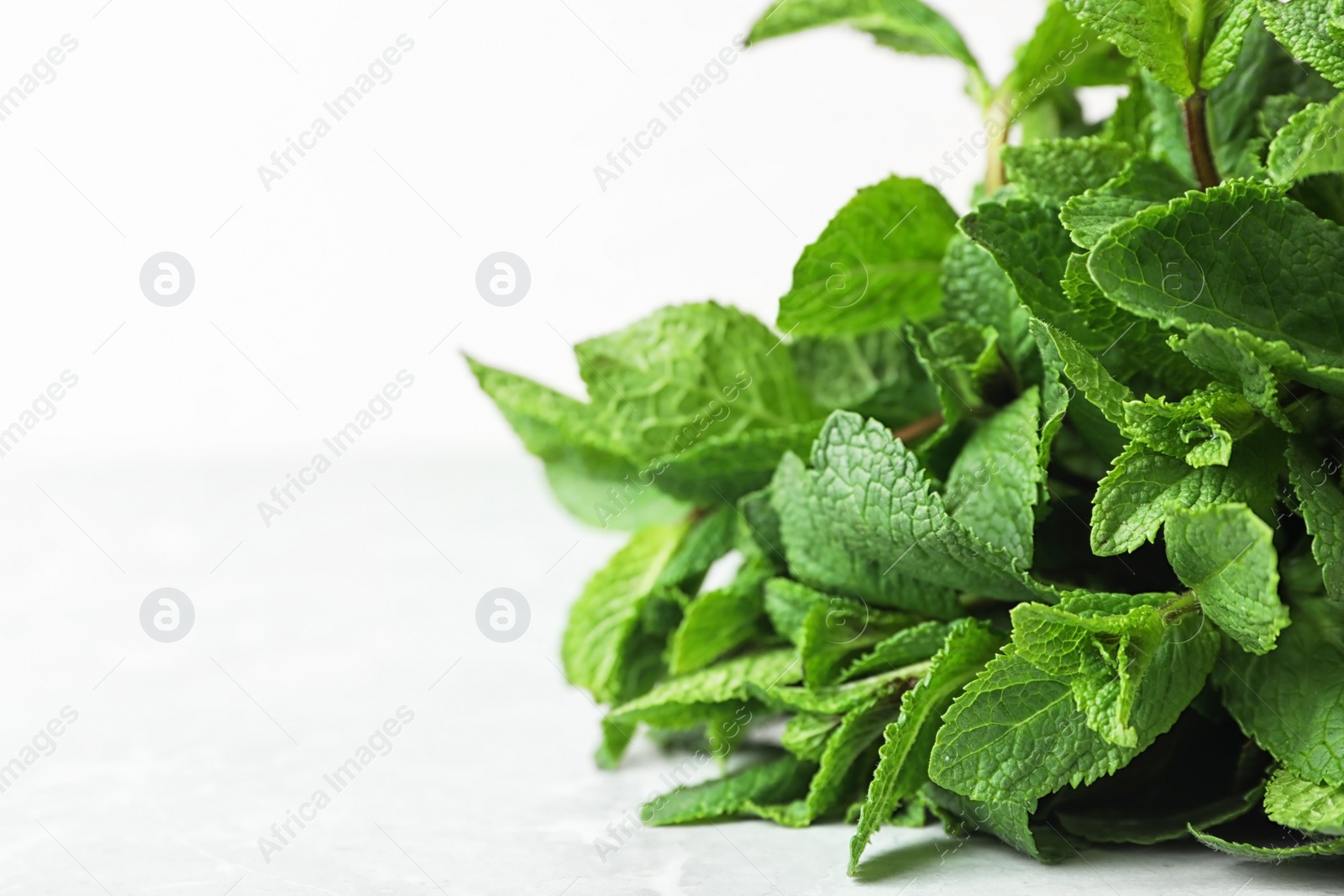 Photo of Bunch of fresh green mint on table, closeup. Space for text